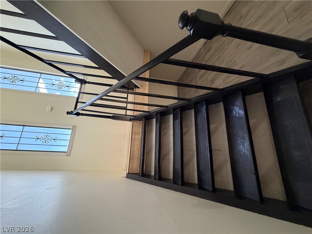 2236 East Desert Inn Road Las Vegas, NV 89169 - Photo 27 of 34 Ascend to the next level on this staircase, featuring elegant dark metal railings and decorative window grilles.