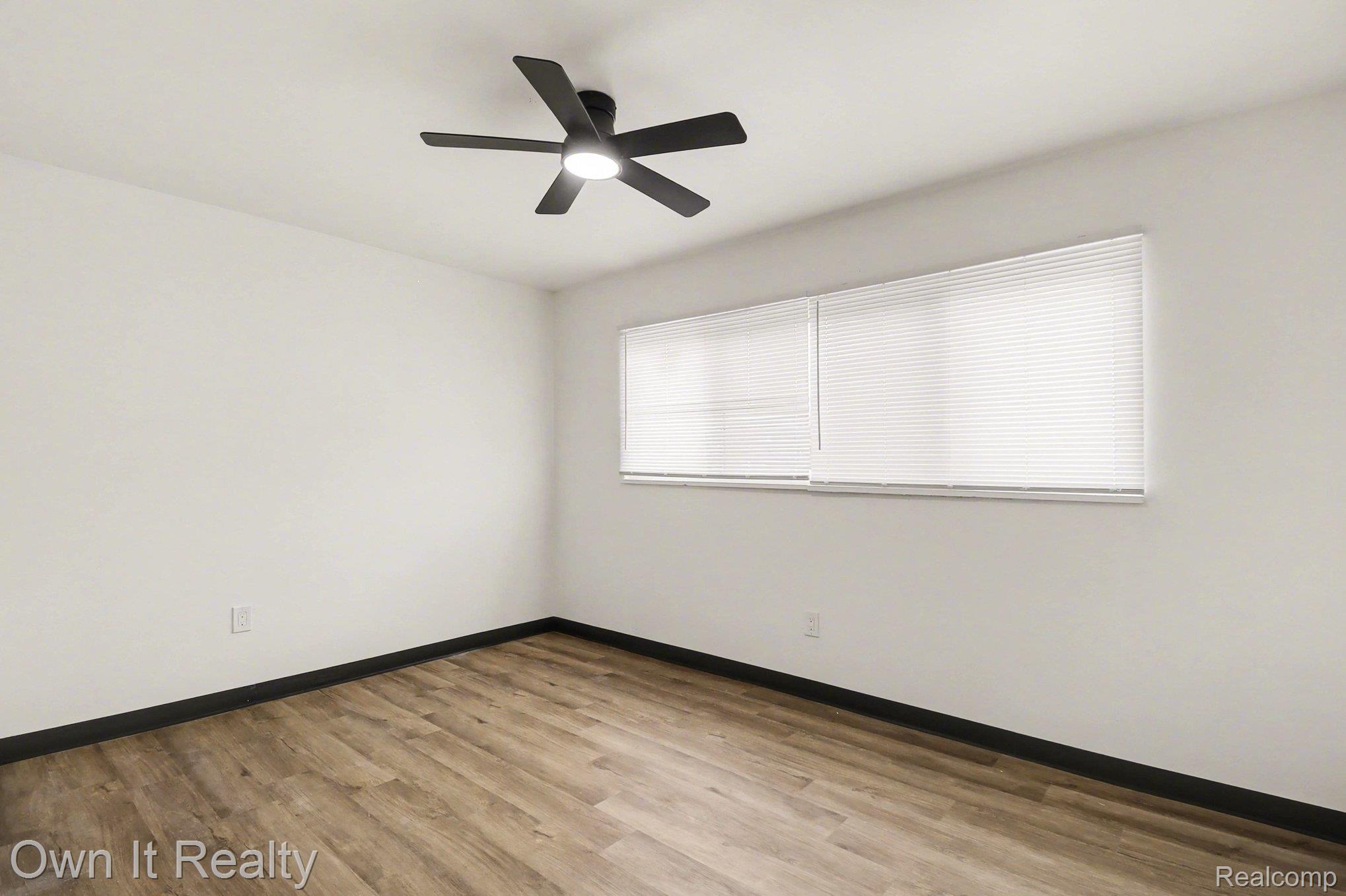 3 Joy Road, Unit 3 Detroit, MI 48228 - Photo 23 of 37 Unfurnished room featuring light wood finished floors and a ceiling fan