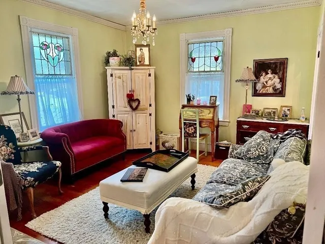 a living room with furniture and a chandelier