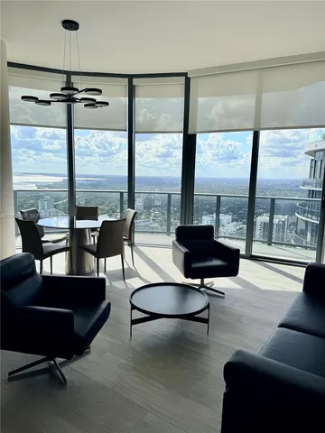 a living room with furniture and large windows
