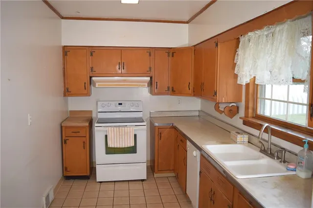 a kitchen with a sink stove and cabinets