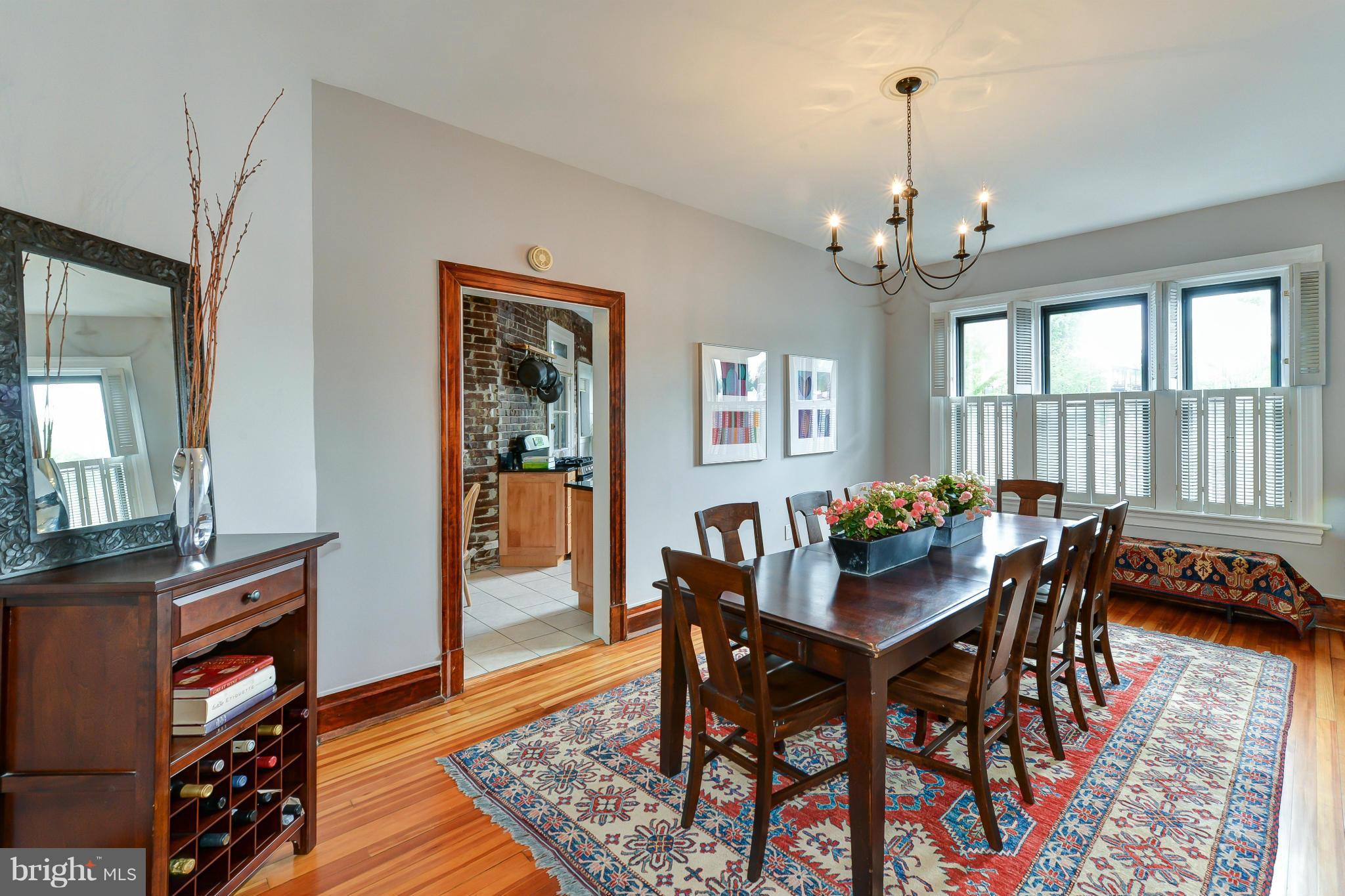 2852 Ontario Road Northwest, Unit 22 Washington, DC 20009 - Photo 11 of 30 a view of a dining room with furniture a rug and wooden floor