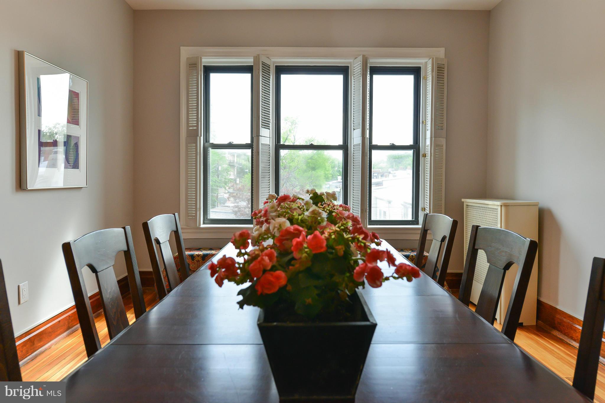 2852 Ontario Road Northwest, Unit 22 Washington, DC 20009 - Photo 12 of 30 a living room with furniture and a potted plant
