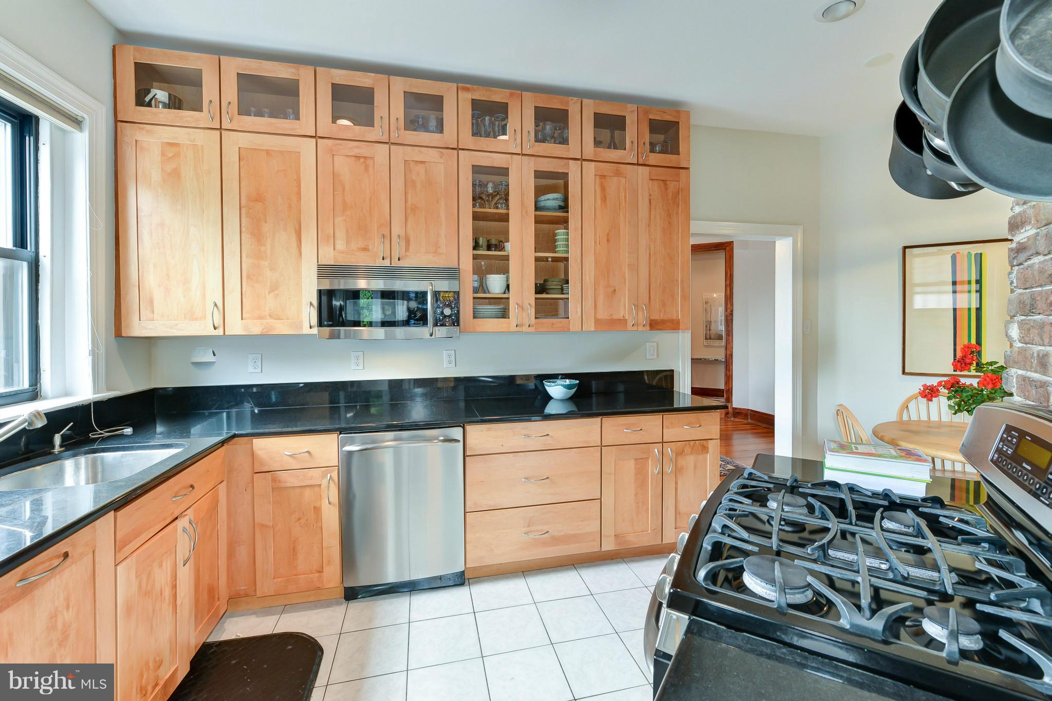 2852 Ontario Road Northwest, Unit 22 Washington, DC 20009 - Photo 16 of 30 a kitchen with stainless steel appliances granite countertop a stove and a sink
