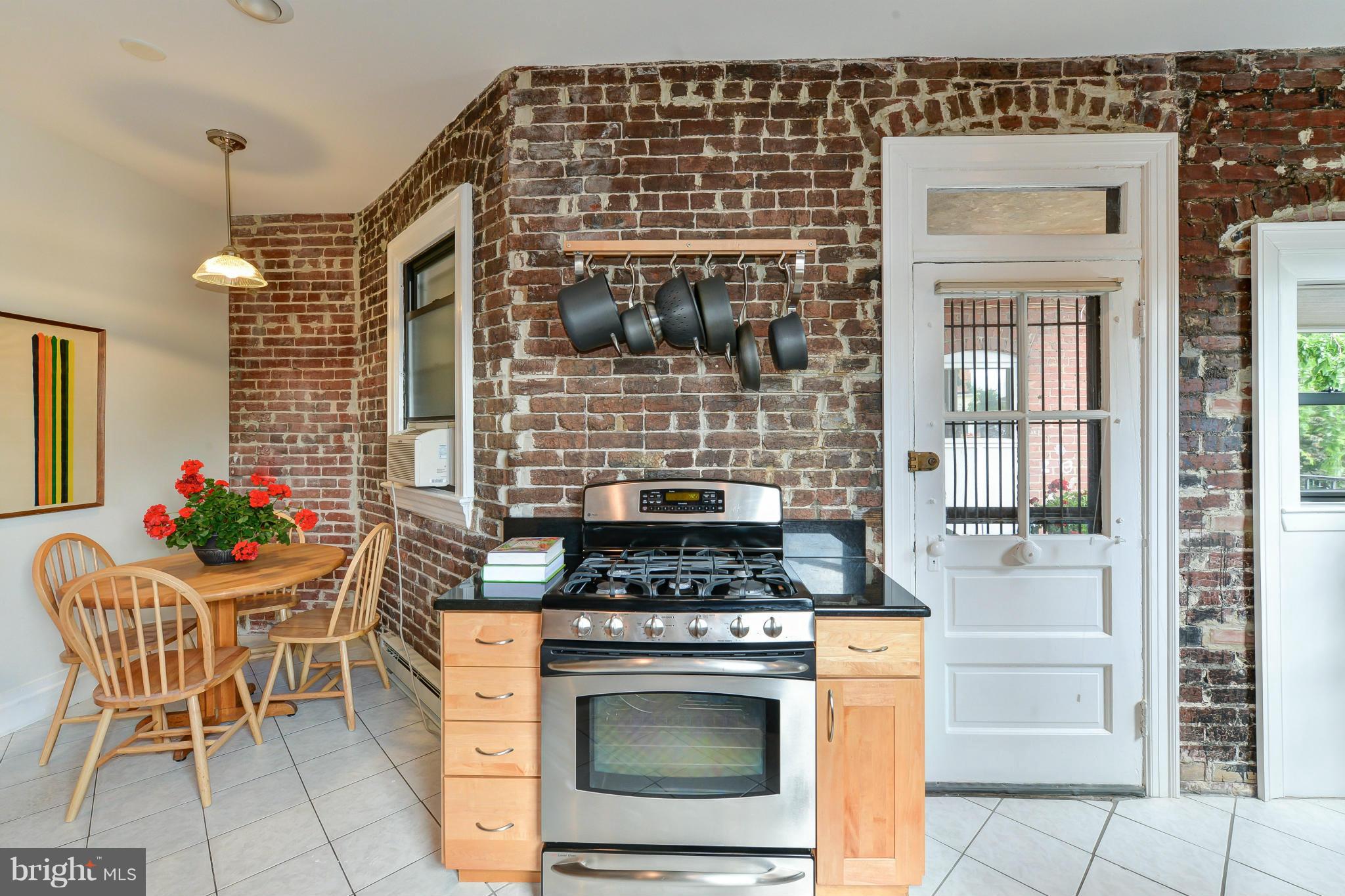 2852 Ontario Road Northwest, Unit 22 Washington, DC 20009 - Photo 17 of 30 a kitchen with a stove and chairs