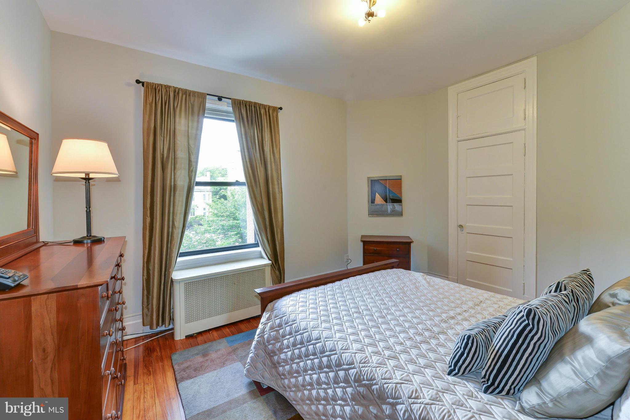 2852 Ontario Road Northwest, Unit 22 Washington, DC 20009 - Photo 19 of 30 a bedroom with a bed and a window