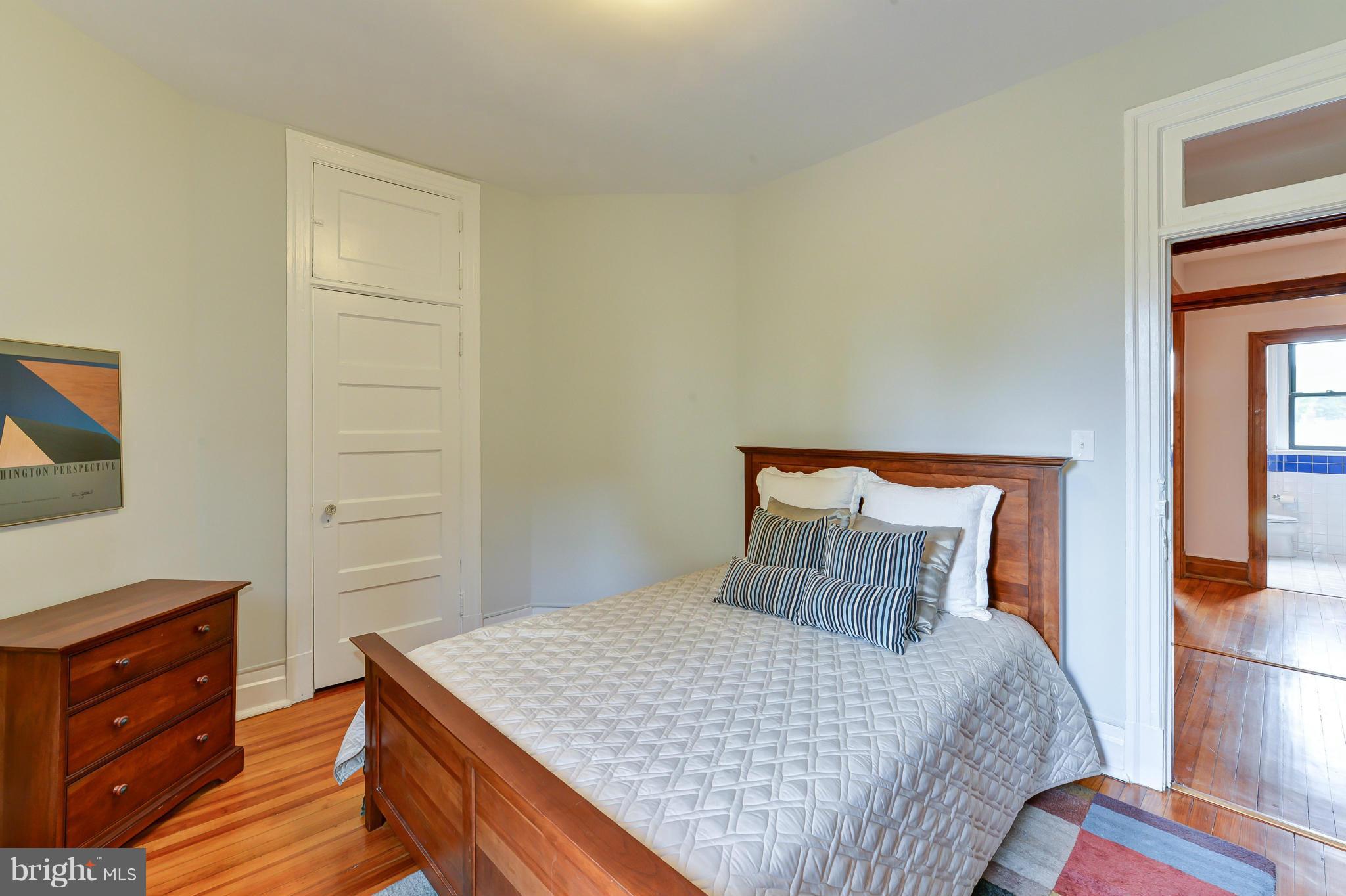 2852 Ontario Road Northwest, Unit 22 Washington, DC 20009 - Photo 20 of 30 a bedroom with a bed and a dresser