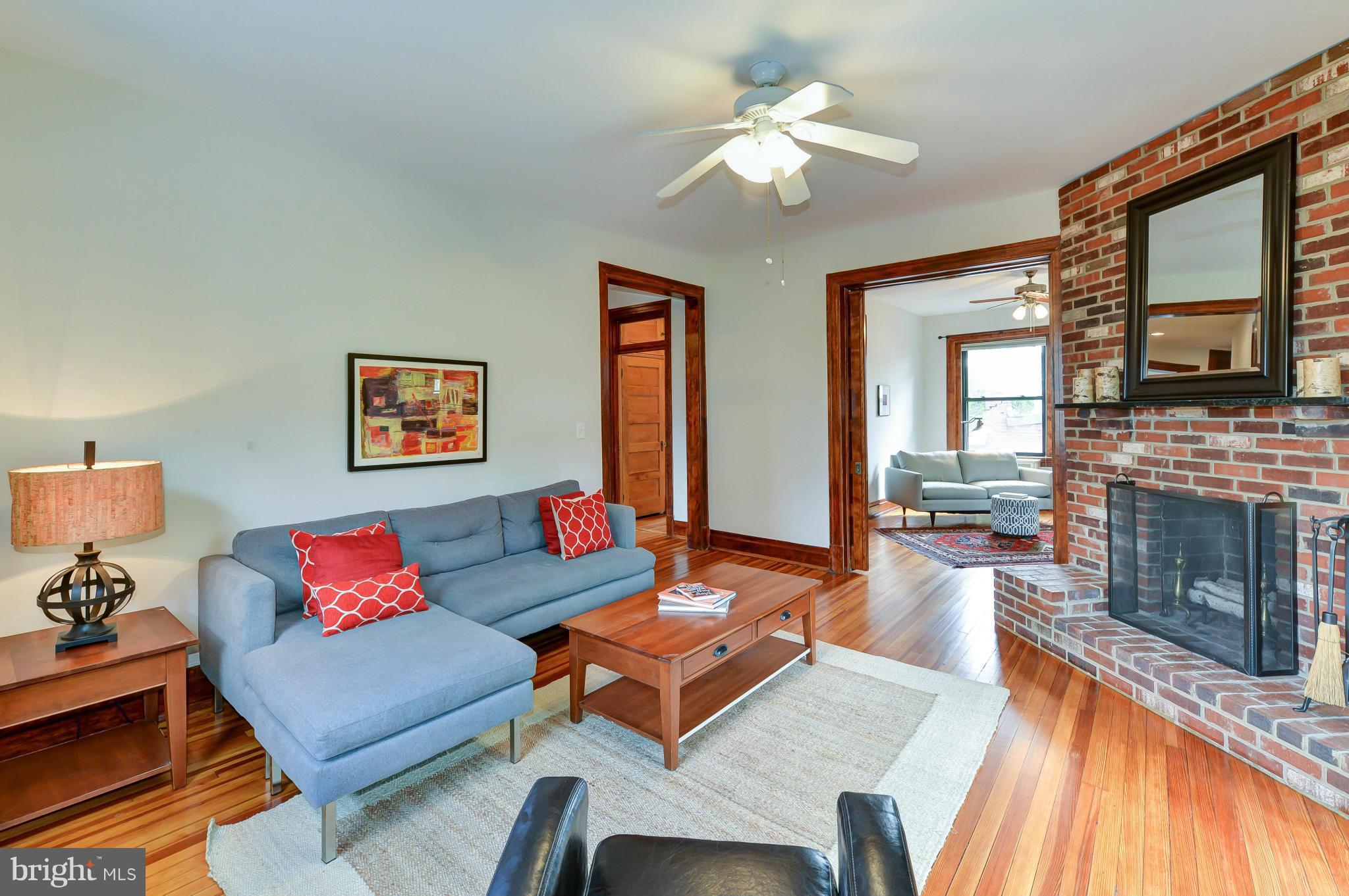 2852 Ontario Road Northwest, Unit 22 Washington, DC 20009 - Photo 3 of 30 a living room with furniture fireplace and a large window