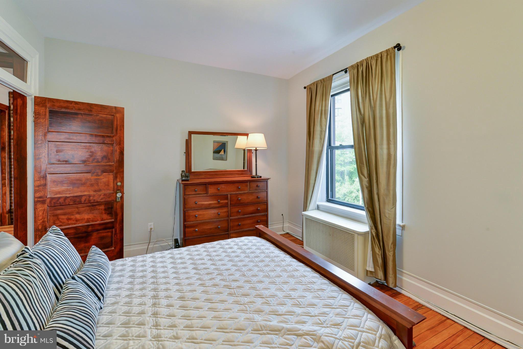 2852 Ontario Road Northwest, Unit 22 Washington, DC 20009 - Photo 21 of 30 a bedroom with a bed and a dresser