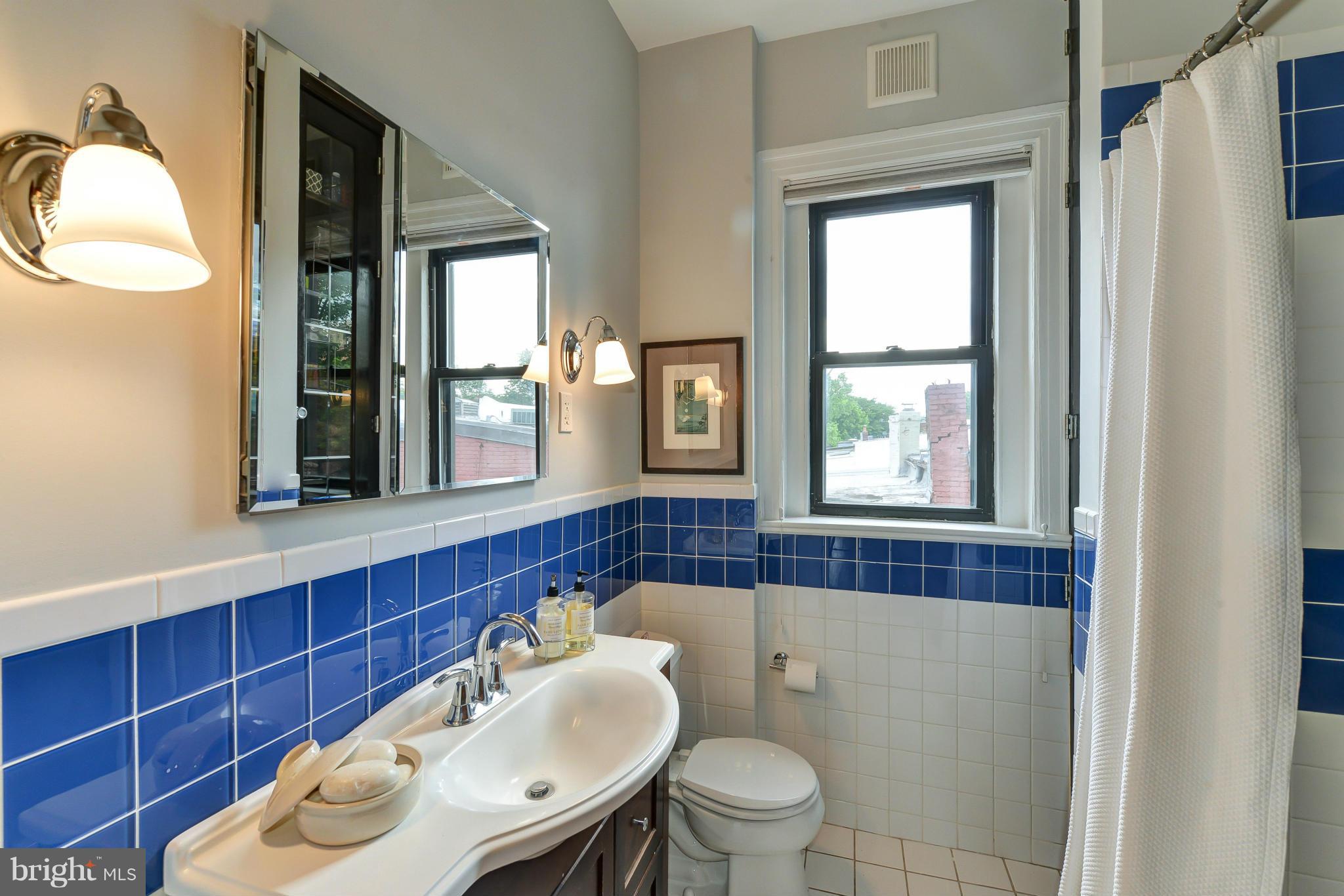 2852 Ontario Road Northwest, Unit 22 Washington, DC 20009 - Photo 22 of 30 a bathroom with a toilet sink and mirror