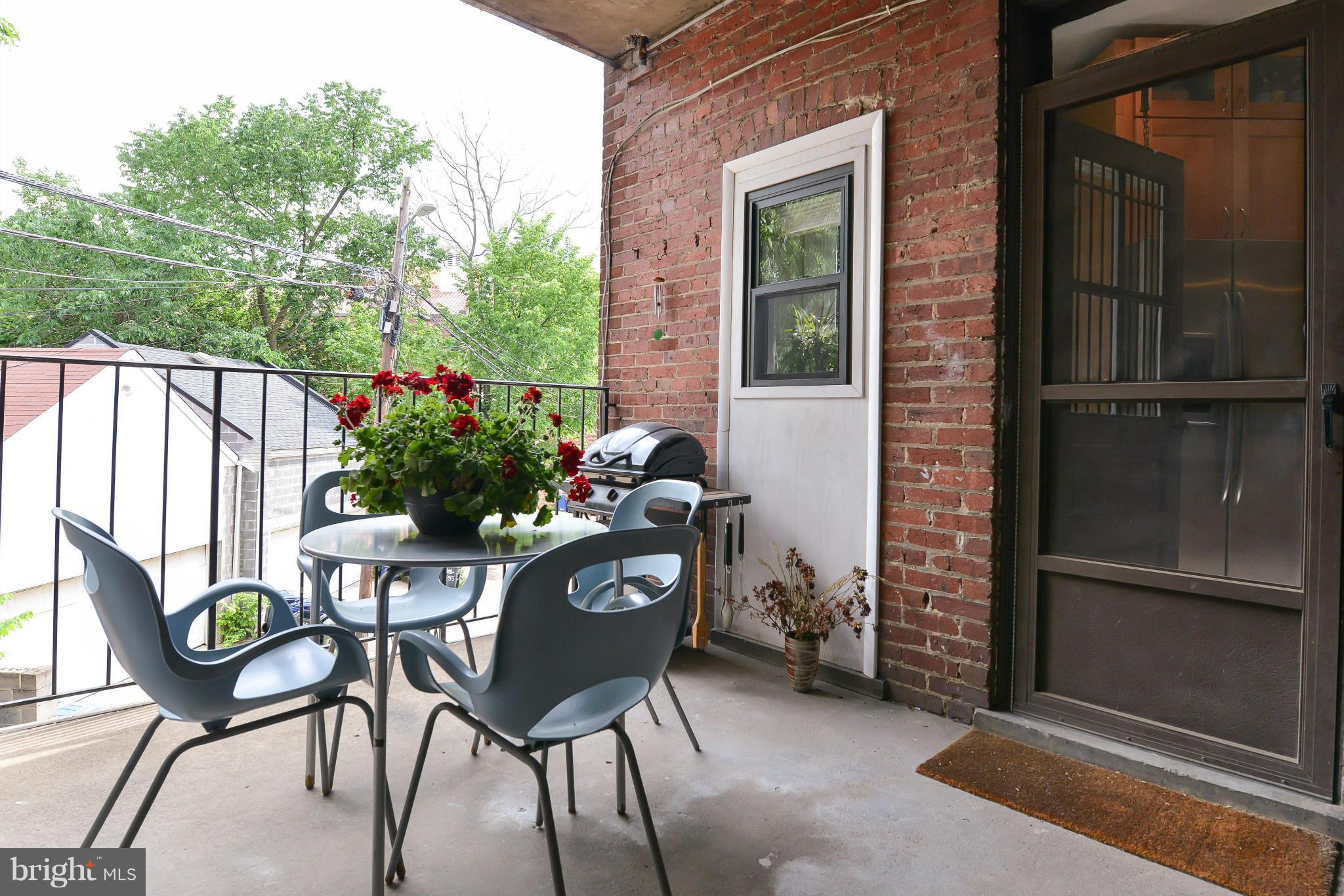 2852 Ontario Road Northwest, Unit 22 Washington, DC 20009 - Photo 27 of 30 a view of a chairs and table in the balcony