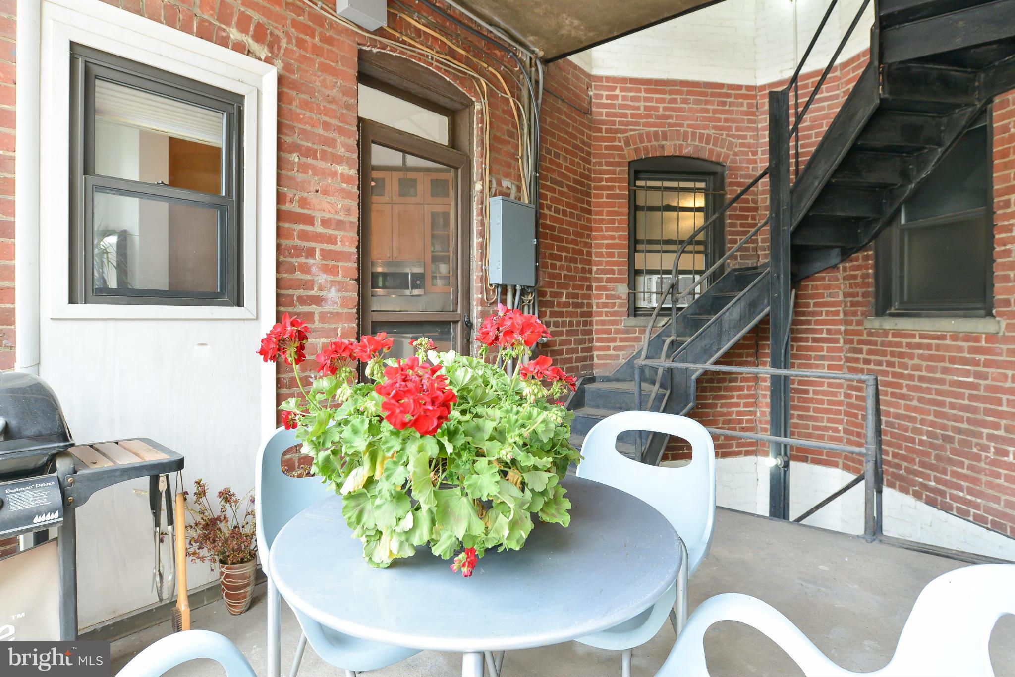 2852 Ontario Road Northwest, Unit 22 Washington, DC 20009 - Photo 28 of 30 a view of a chairs and table in a patio