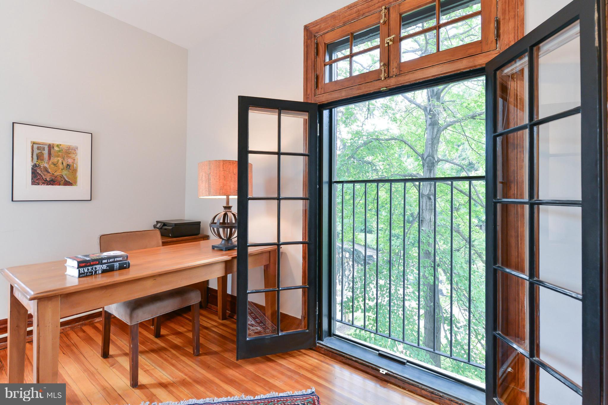 2852 Ontario Road Northwest, Unit 22 Washington, DC 20009 - Photo 5 of 30 a view of a workspace with furniture and a window
