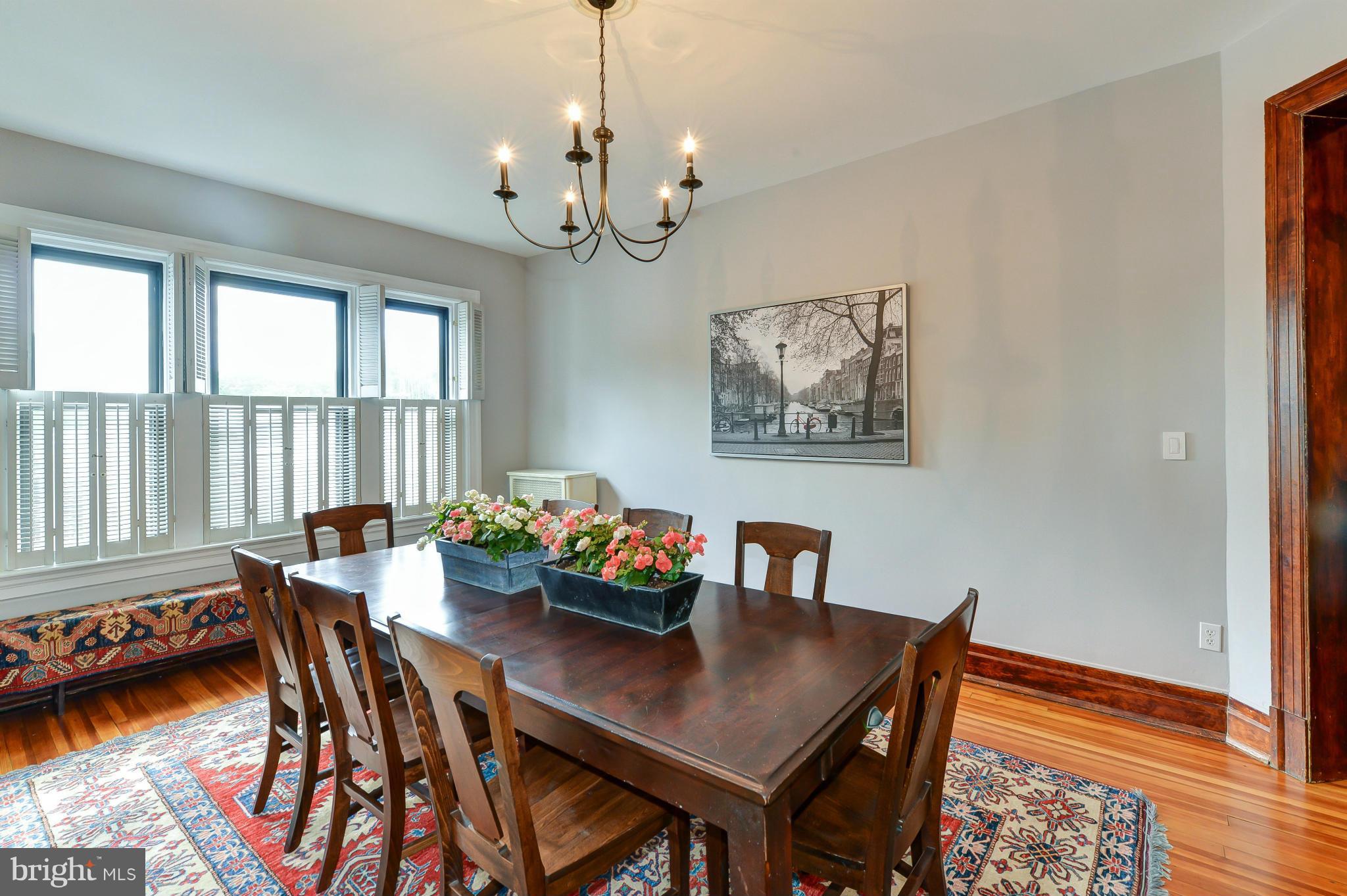 2852 Ontario Road Northwest, Unit 22 Washington, DC 20009 - Photo 10 of 30 a view of a dining room with furniture a chandelier and wooden floor