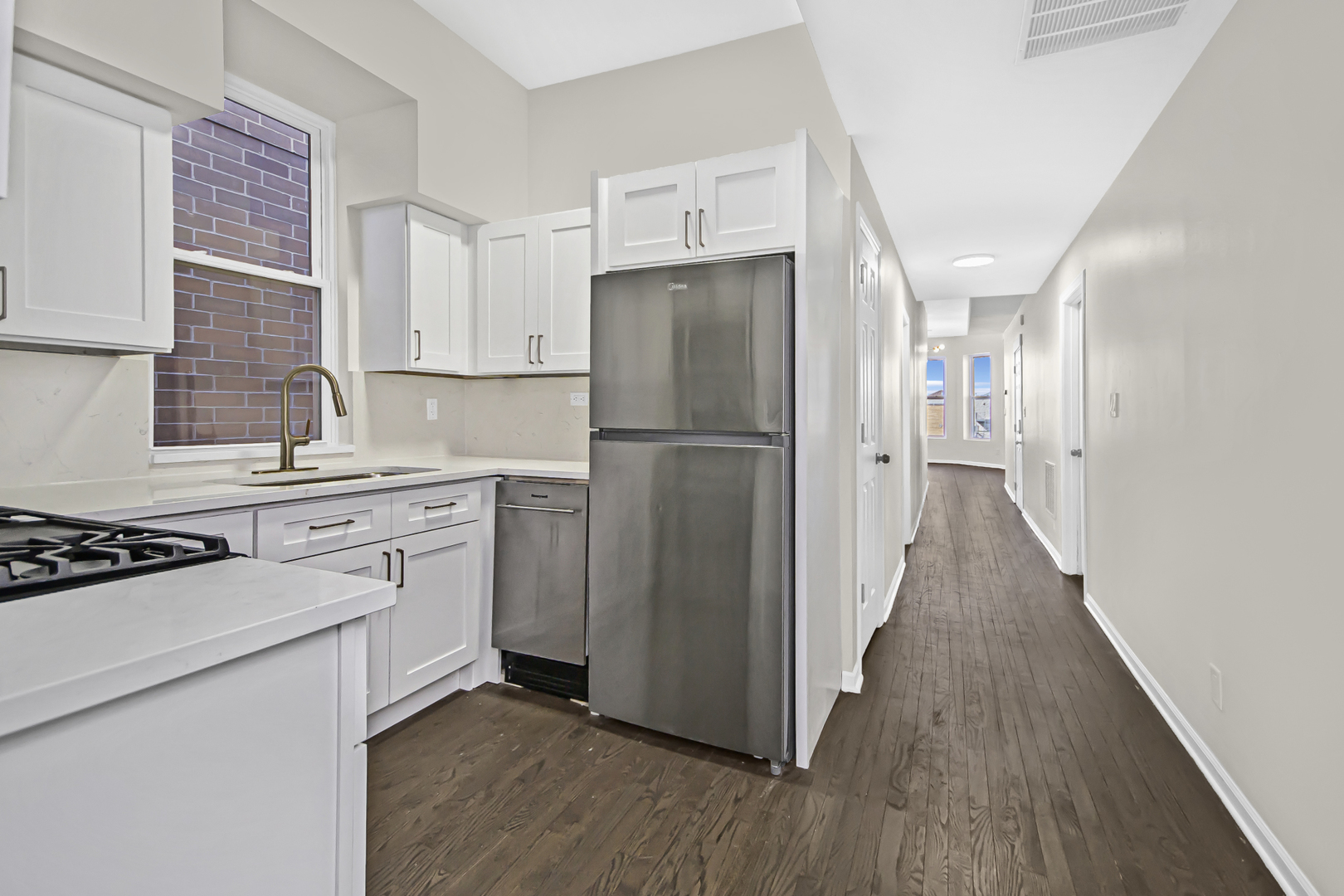 1337 North Western Avenue, Unit 3 Chicago, IL 60622 - Photo 15 of 17 a kitchen with a refrigerator a stove top oven and wooden floor