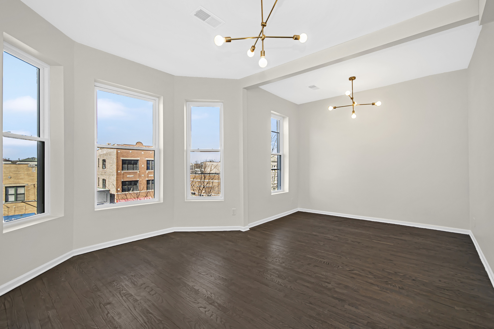 1337 North Western Avenue, Unit 3 Chicago, IL 60622 - Photo 3 of 17 a view of an empty room with wooden floor and a window