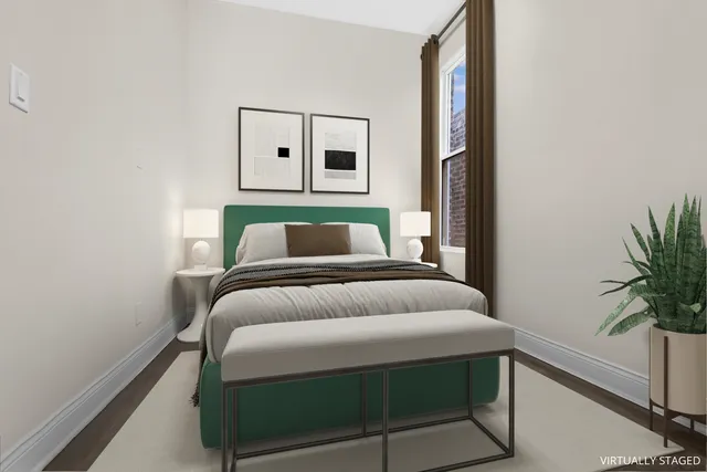 a bedroom with a bed and a potted plant