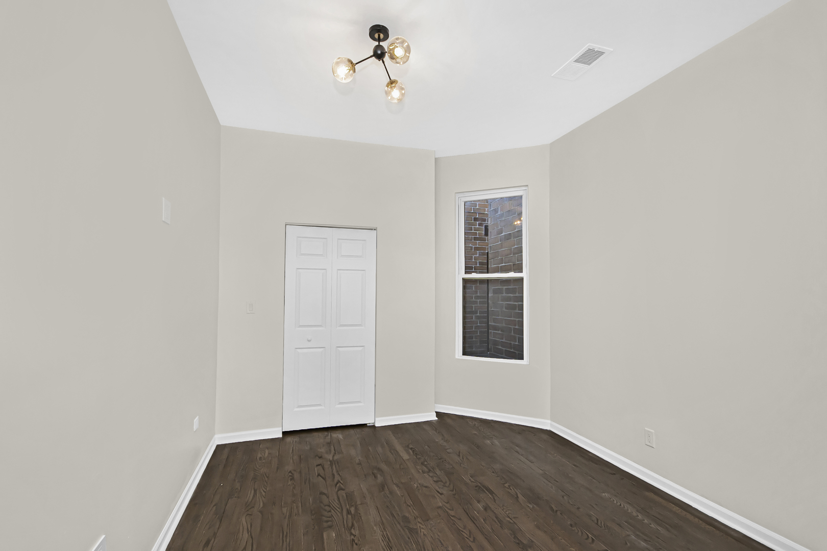 1337 North Western Avenue, Unit 3 Chicago, IL 60622 - Photo 9 of 17 an empty room with wooden floor and windows