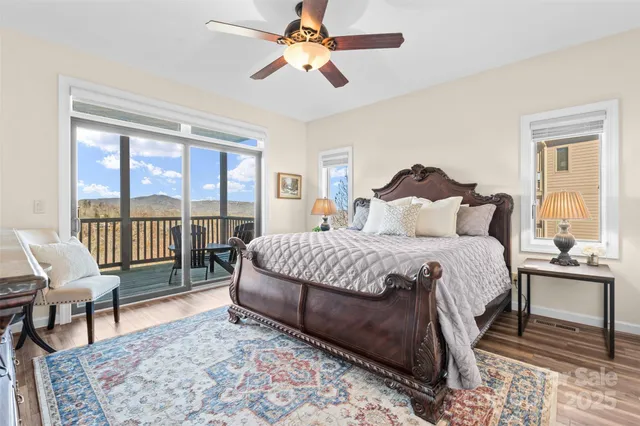 a bedroom with a bed a chandelier and a window