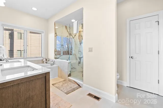 a spacious bathroom with a sink a mirror and a bathtub