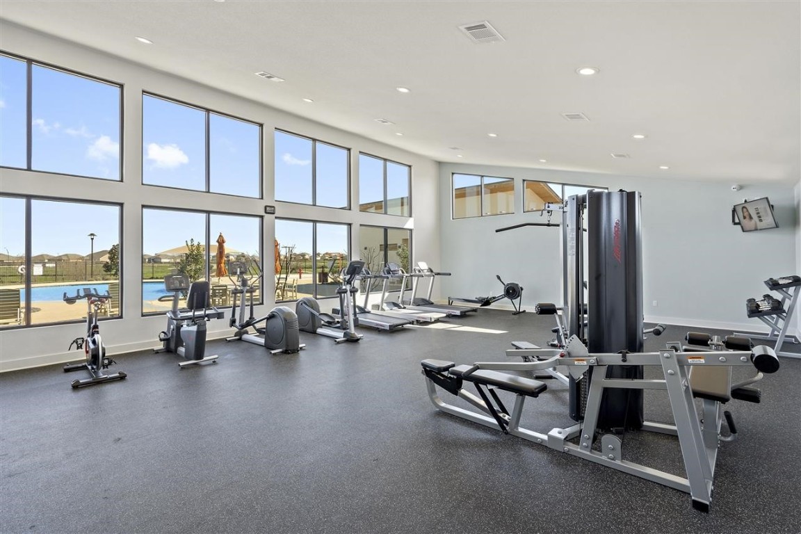 a view of a room with gym equipment and floor to ceiling window