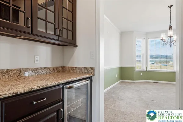 a large kitchen with granite countertop a stove and a sink