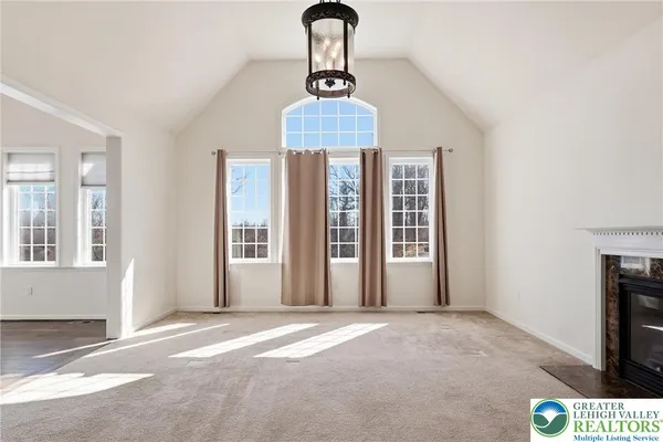 a view of hallway with a floor to ceiling window and wooden floor