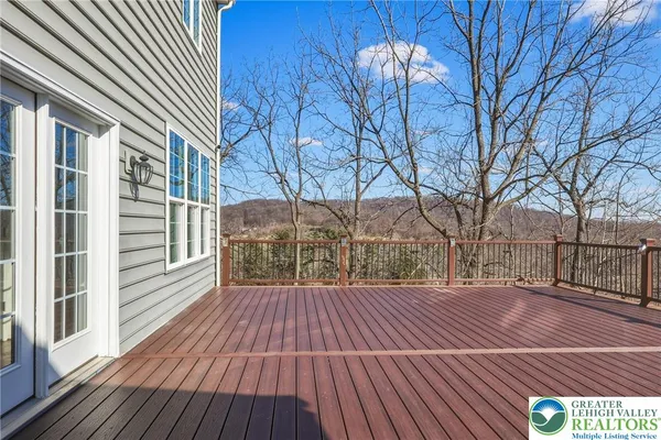 a view of a house with wooden fence