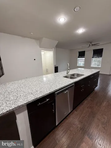 a modern kitchen with granite countertop stainless steel appliances and wooden cabinets