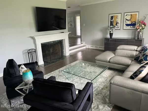 a living room with furniture a flat screen tv and a fireplace