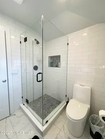 a bathroom with a toilet and a shower