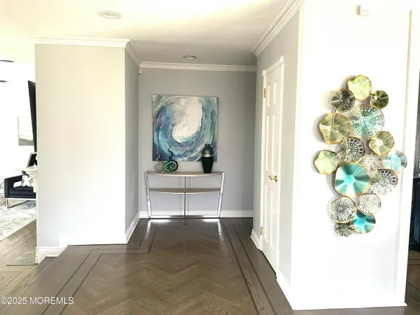 a view of a hallway to a livingroom with furniture