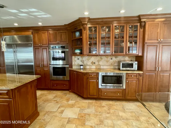 a kitchen with stainless steel appliances granite countertop a stove and a refrigerator
