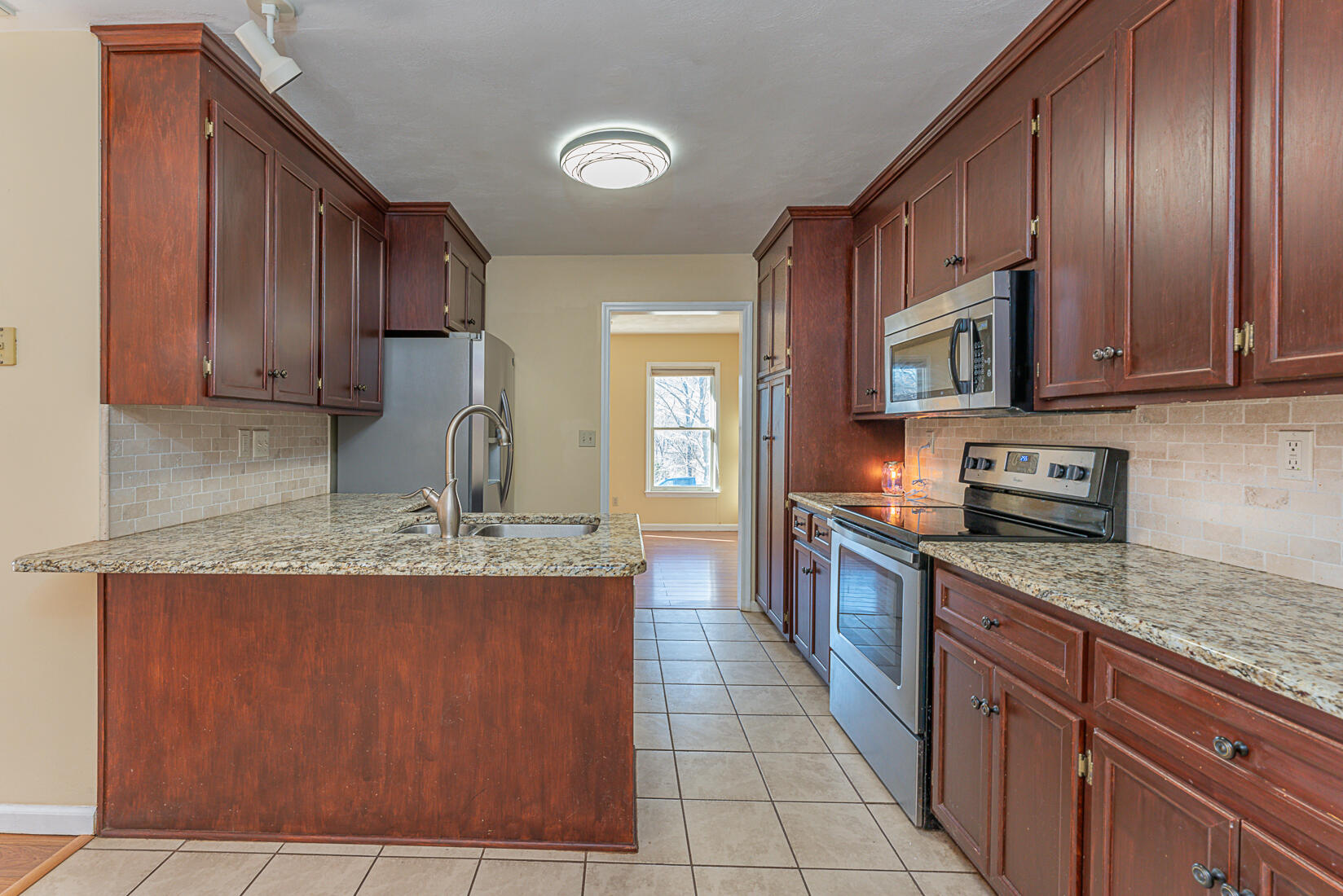 3490 Saunders Road Vinton, VA 24179 - Photo 20 of 60 a large kitchen with granite countertop a stove sink and cabinets