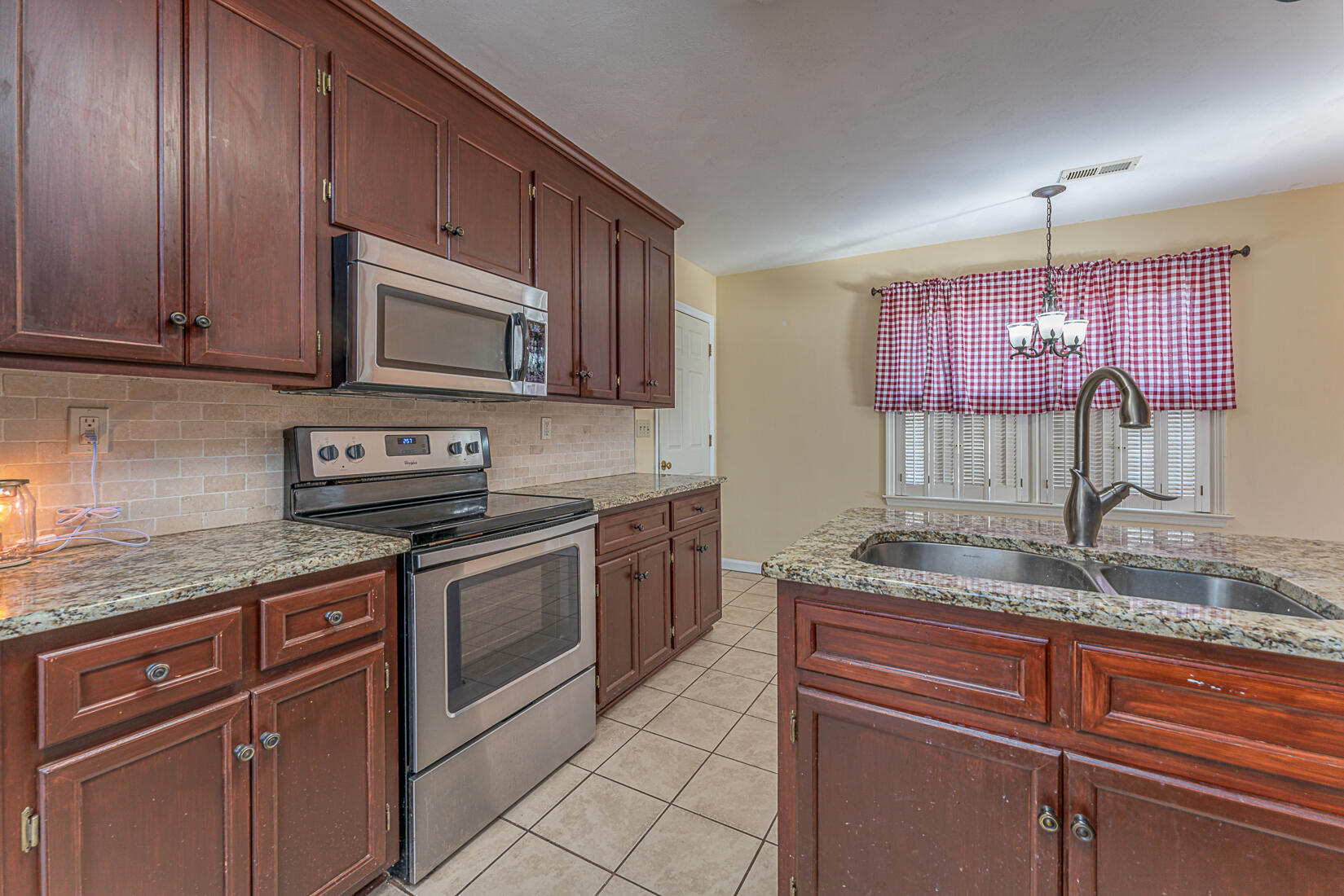 3490 Saunders Road Vinton, VA 24179 - Photo 21 of 60 a kitchen with granite countertop stainless steel appliances stove microwave and sink