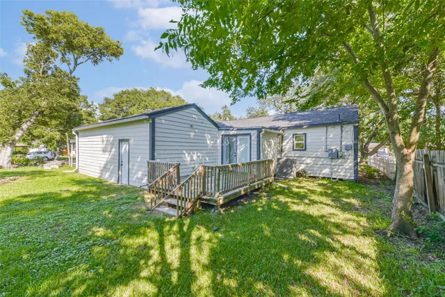 a view of a house with a yard and sitting area