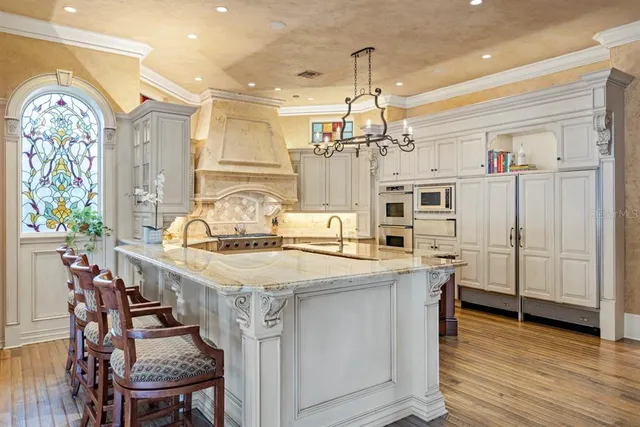 a spacious bathroom with a granite countertop sink a mirror a vanity and a bathtub