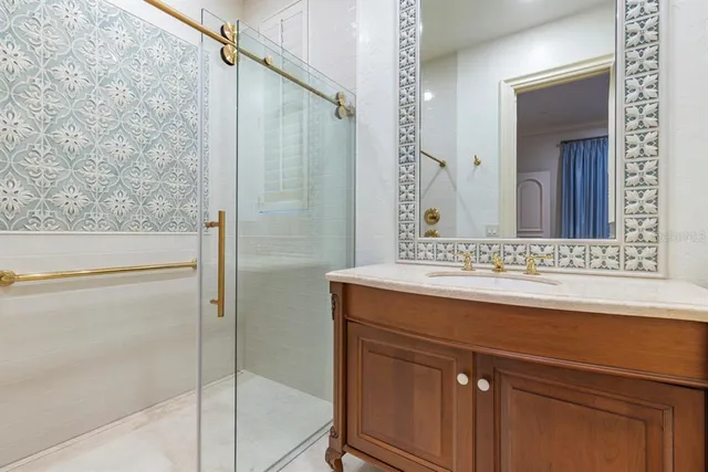 a bathroom with a granite countertop sink and a mirror