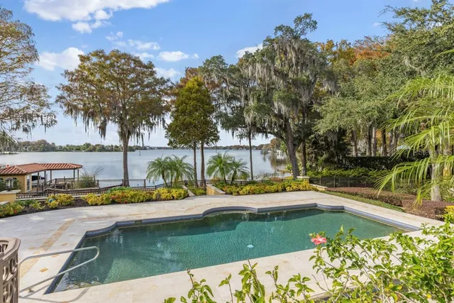 a front view of a residential apartment building with a yard and potted plants