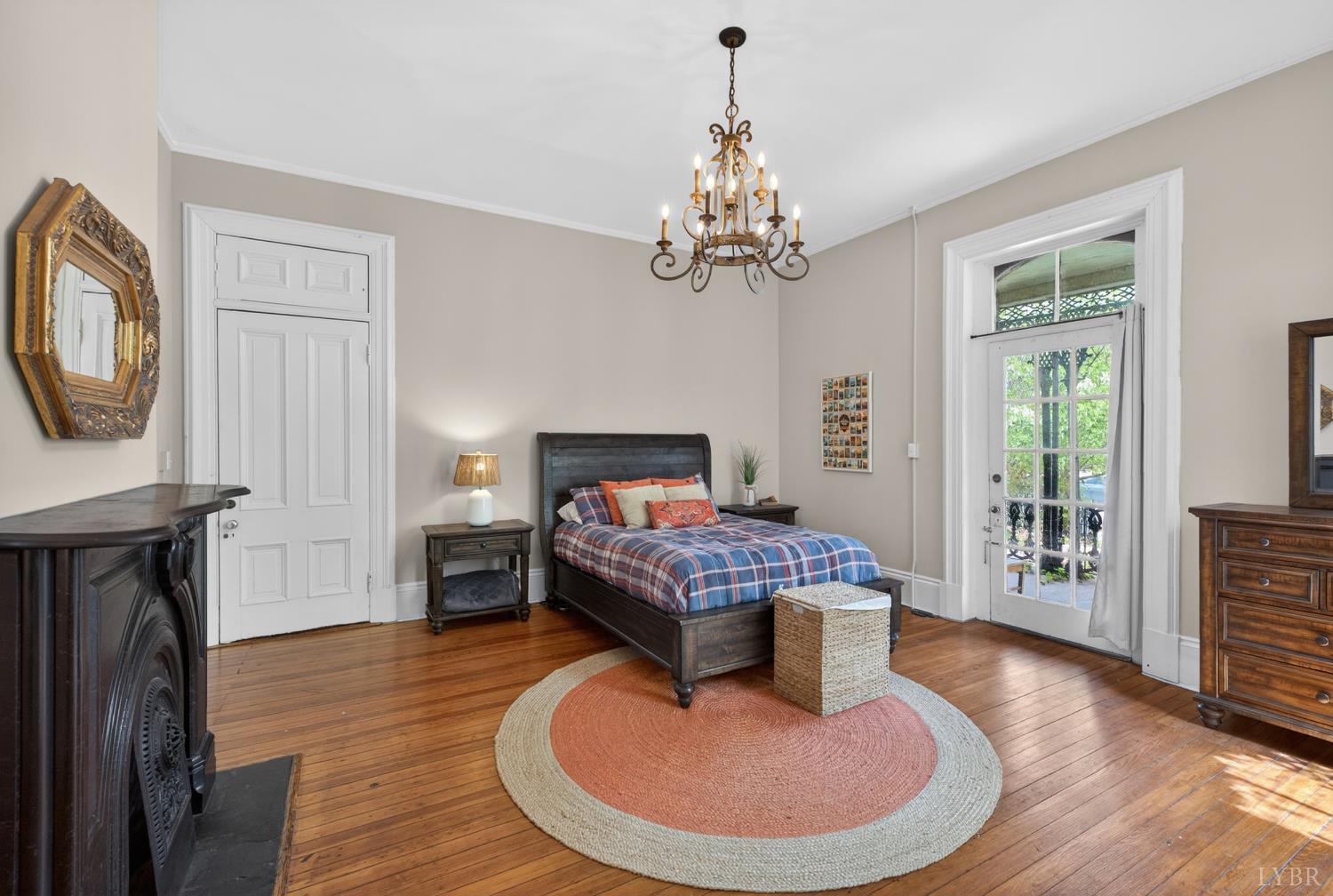 1007 Court Street Lynchburg, VA 24504 - Photo 30 of 90 a living room with furniture a fireplace and a chandelier