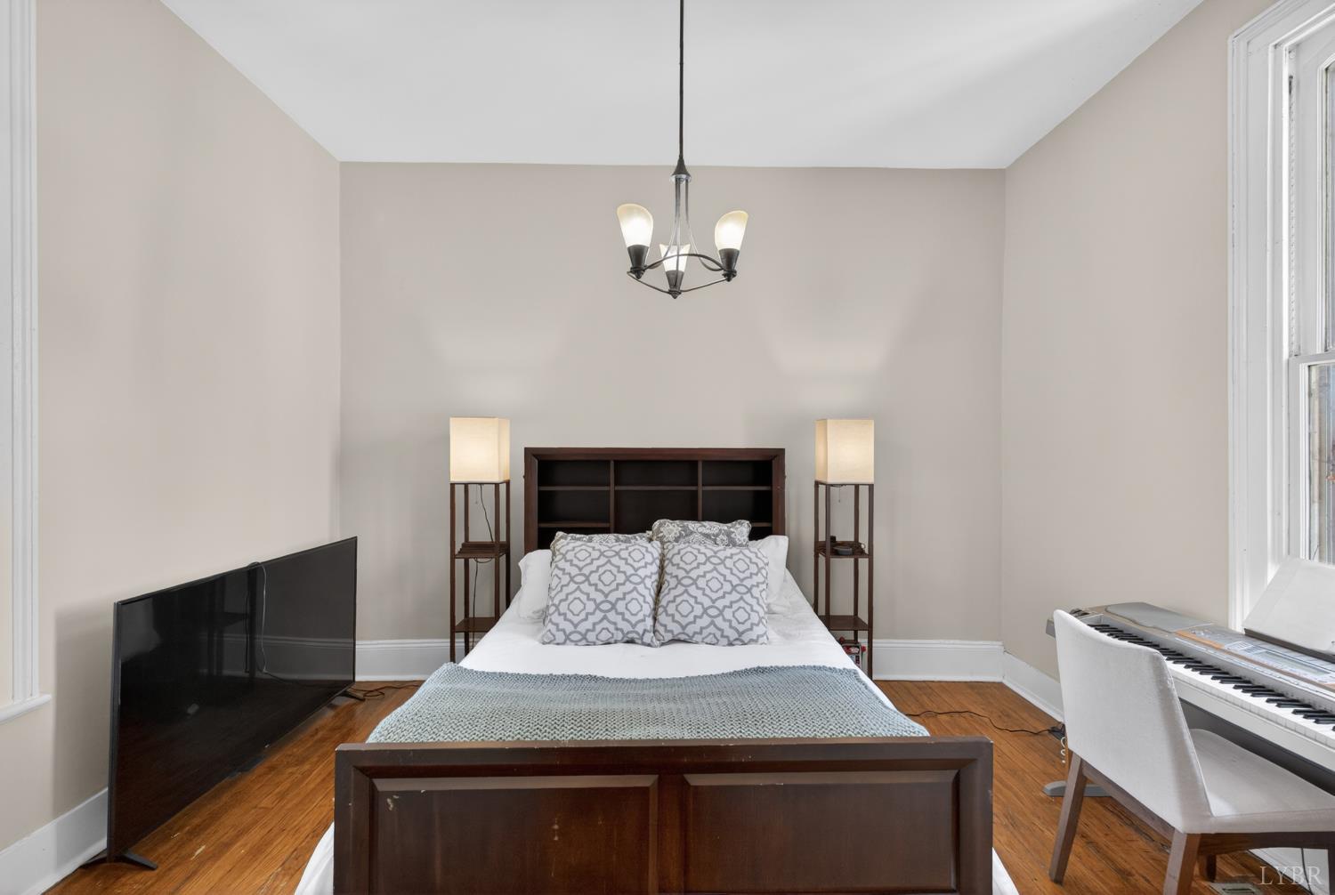 1007 Court Street Lynchburg, VA 24504 - Photo 34 of 90 a bedroom with a bed and a chandelier