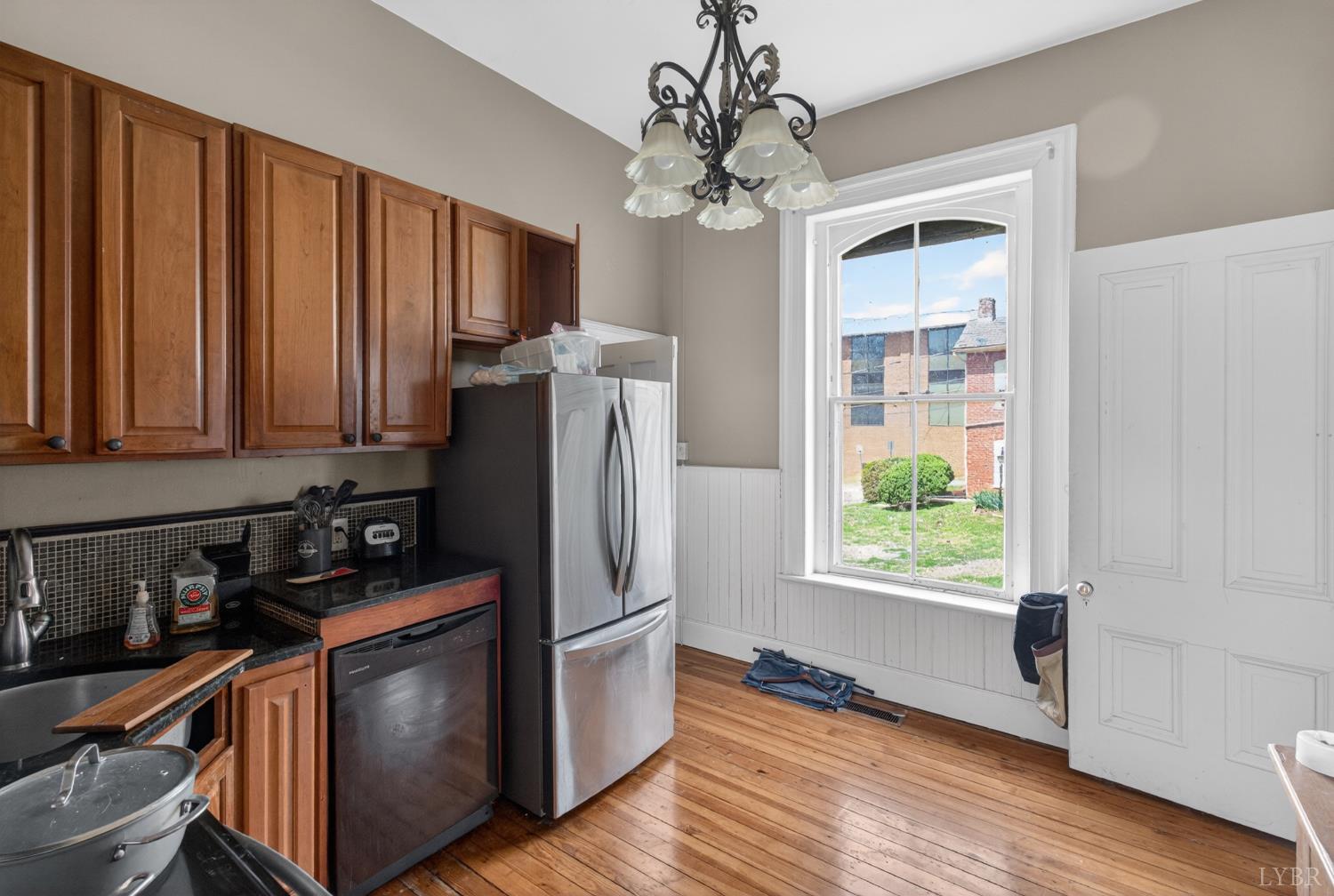 1007 Court Street Lynchburg, VA 24504 - Photo 47 of 90 a kitchen with stainless steel appliances granite countertop a refrigerator a stove a sink and dishwasher with wooden floor