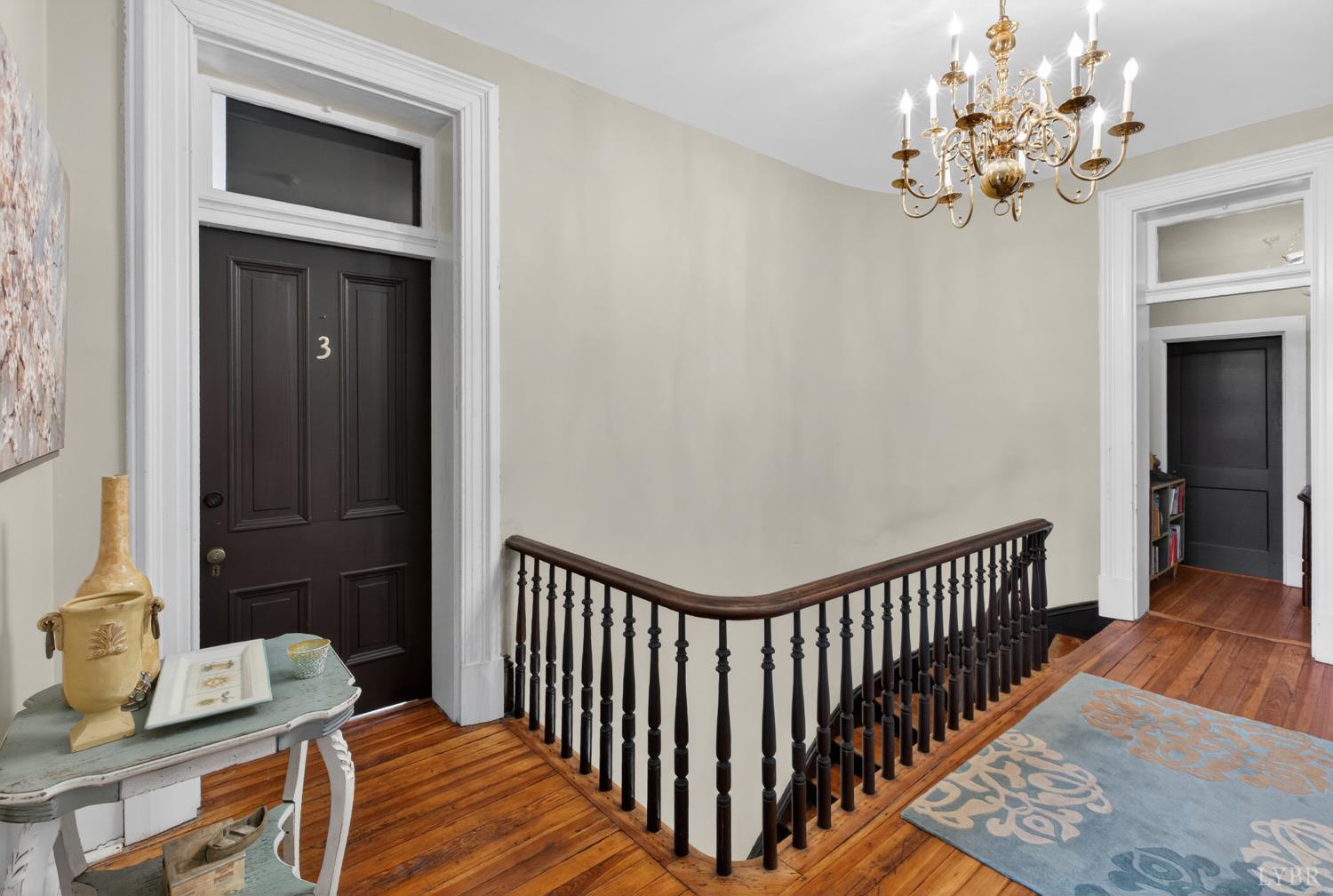 1007 Court Street Lynchburg, VA 24504 - Photo 54 of 90 a view of a hallway with wooden floor and a chandelier