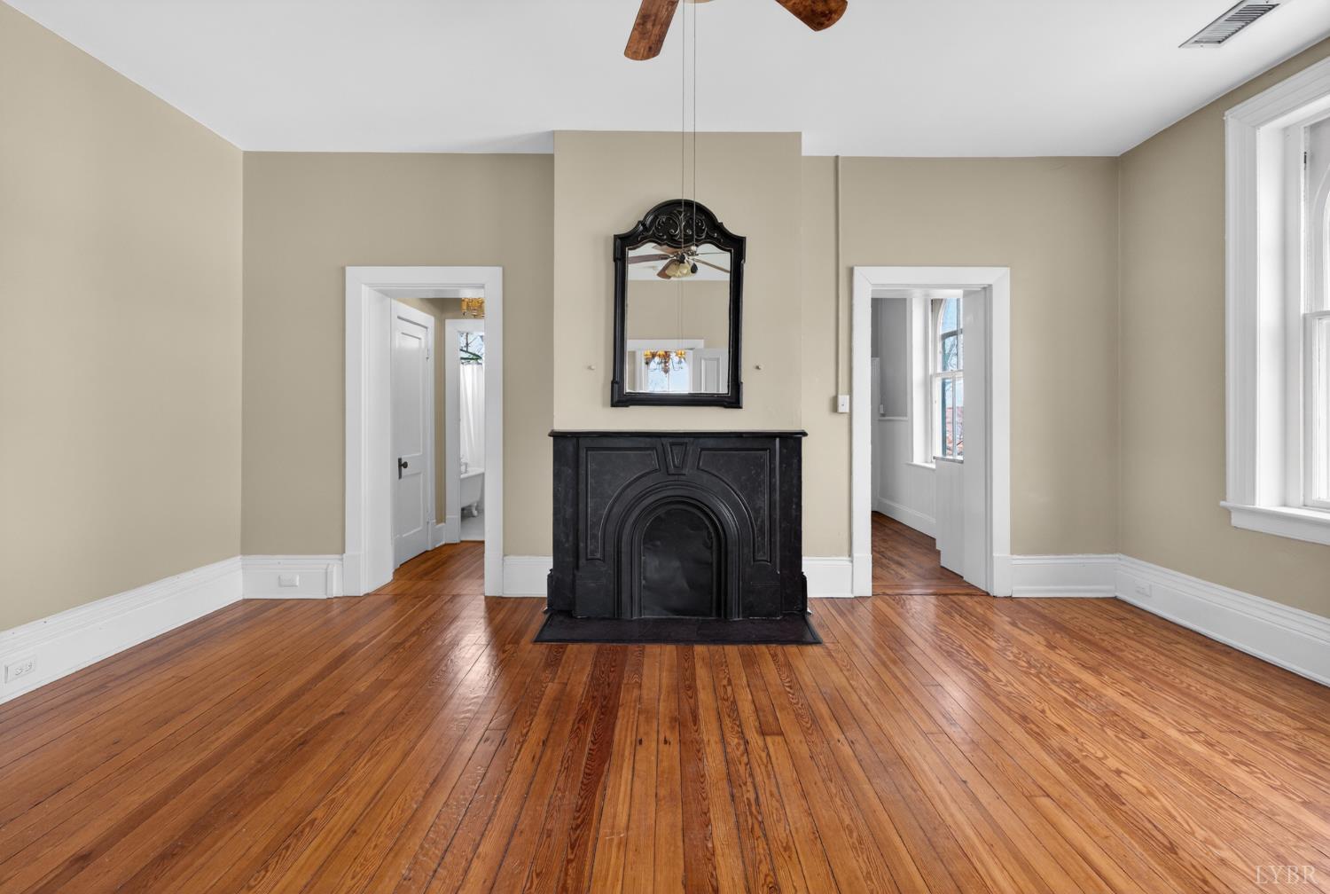 1007 Court Street Lynchburg, VA 24504 - Photo 59 of 90 a view of a livingroom with wooden floor a fireplace and windows