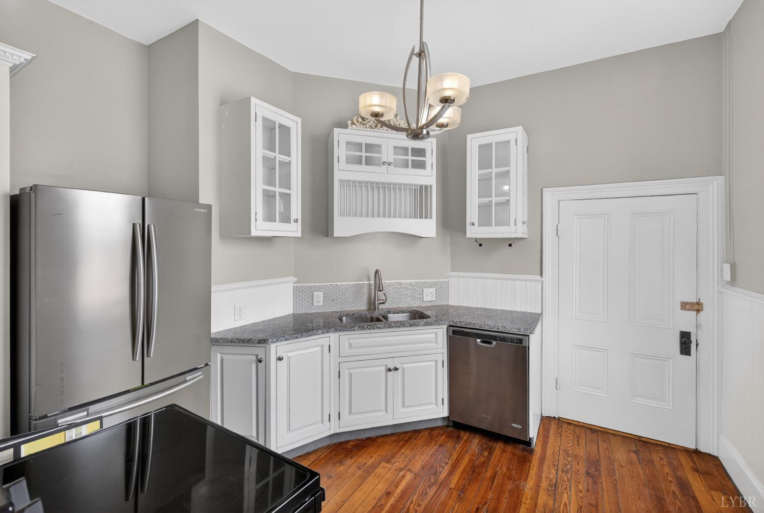 1007 Court Street Lynchburg, VA 24504 - Photo 62 of 90 a kitchen with stainless steel appliances granite countertop a refrigerator a sink dishwasher a stove and white countertops with wooden floor