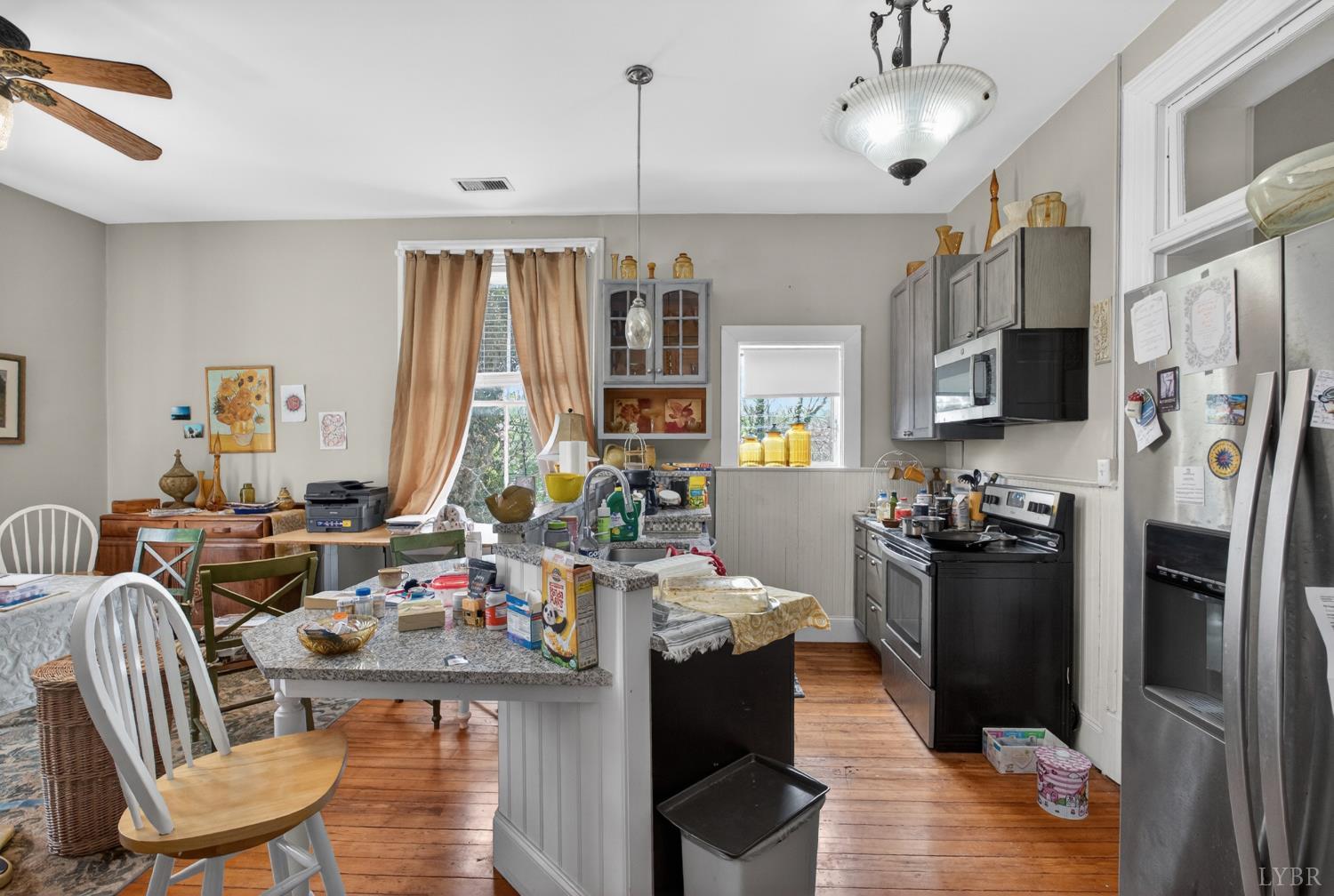 1007 Court Street Lynchburg, VA 24504 - Photo 69 of 90 a kitchen with stainless steel appliances granite countertop a refrigerator oven stove a sink dishwasher a dining table and chairs with wooden floor