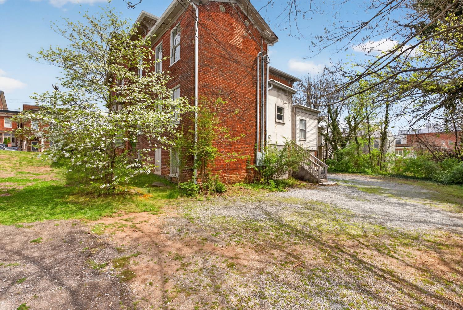 1007 Court Street Lynchburg, VA 24504 - Photo 84 of 90 a view of a brick house with a yard and large tree