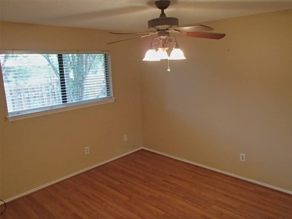 617 Luther Drive, Unit B Georgetown, TX 78628 - Photo 4 of 13 a view of a room with a large window wooden floor and chandelier
