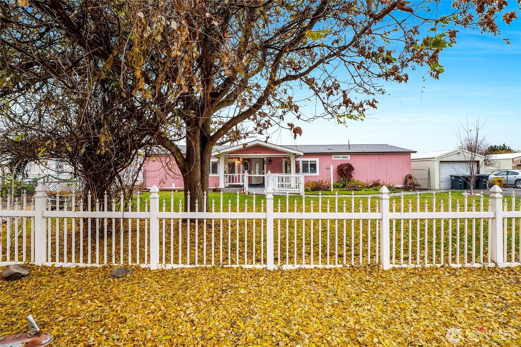 a view of a house with a small yard and wooden fence