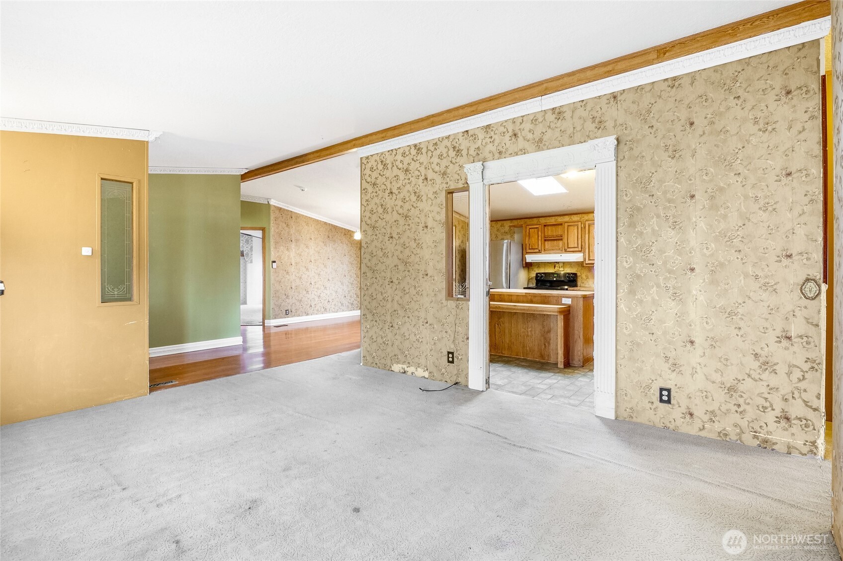 8674 Vince Road Northeast Moses Lake, WA 98837 - Photo 14 of 39 an empty room with kitchen view and wooden floor